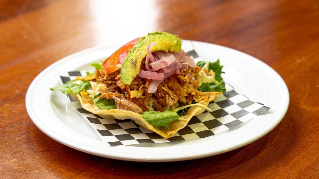 TOSTADAS  · Fried corn tortilla, refried black bean spread, topped with lettuce, cabbage, pickled red onions, avocado, queso fresco, and your choice of meat