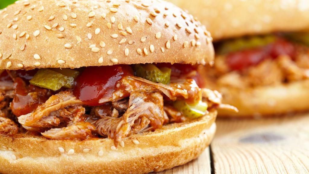 Spicy Slow Cooked Pork Torta · A delicious sandwich made with Mexican bread and filled with marinated spicy Slow cooked pork, cabbage, onions, and pickles.