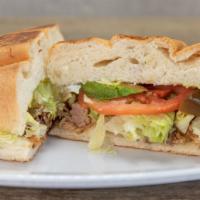 Spicy Pork Chop Torta · A delicious sandwich made with Mexican bread and filled with Grilled spicy Pork chops, beans...