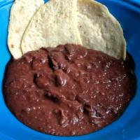 Side of Beans · A side dish of refried black beans.