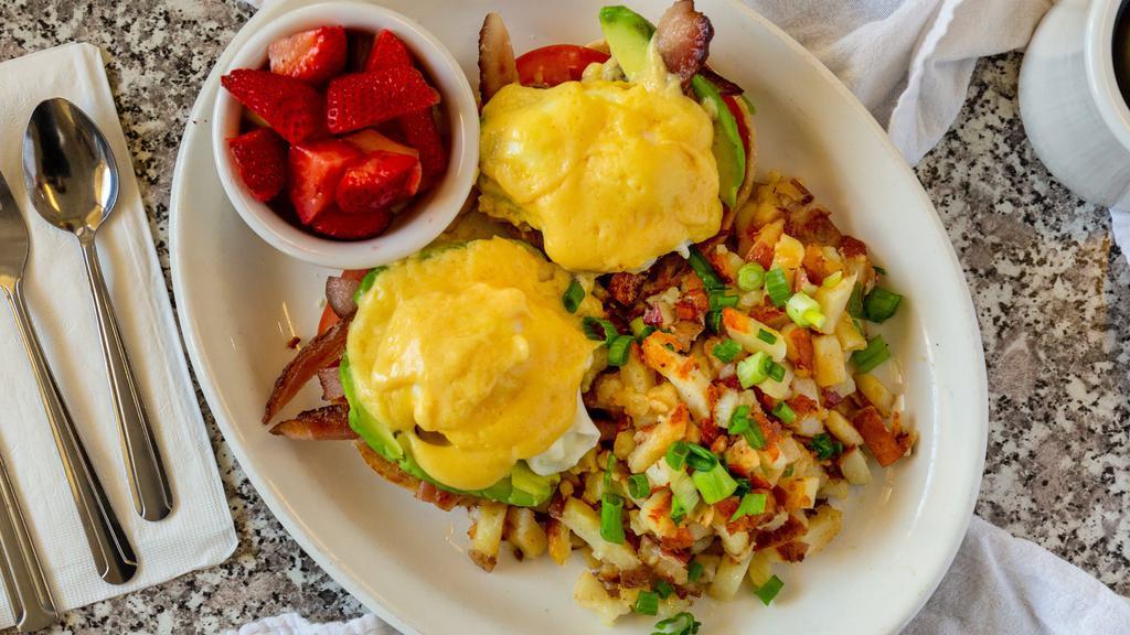 California Benedict · Grilled English muffin halves topped with three strips of bacon, grilled tomato slices, avocado, poached eggs, and topped with hollandaise sauce.