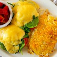 Eggs Florentine · Grilled English muffin halves topped with sliced tomato, fresh spinach, poached eggs, and to...