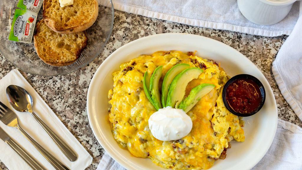 Santa Fe Skillet · Bacon and green chiles scrambled with eggs and topped with avocado and melted cheese. Served with salsa and sour cream on the side.