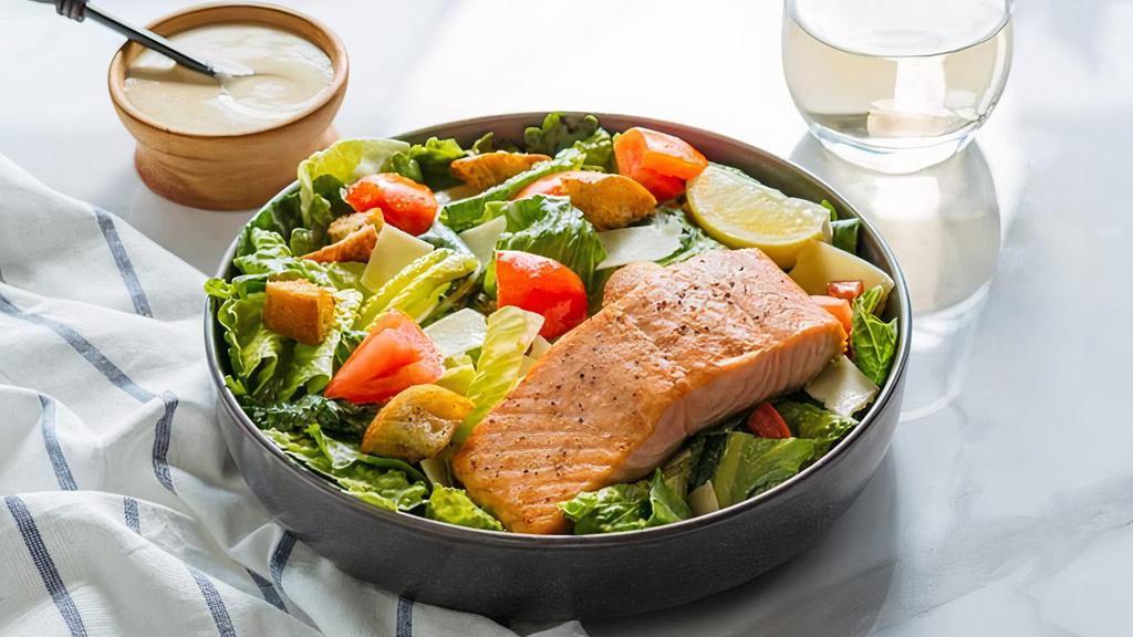 Grilled Salmon Caesar Salad · romaine lettuce, organic baby kale, grilled sustainable salmon, organic tomatoes, garlic croutons, shaved asiago, caesar dressing