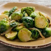 Roasted Brussel Sprouts W. Turkey Bacon · crispy turkey bacon, roasted garlic, sweet yellow onion, finished with a squeeze of fresh le...