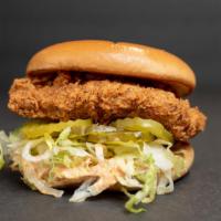 Main Chick · Cluck sauce, fried chick'n, lettuce, pickles on a vegan brioche bun.