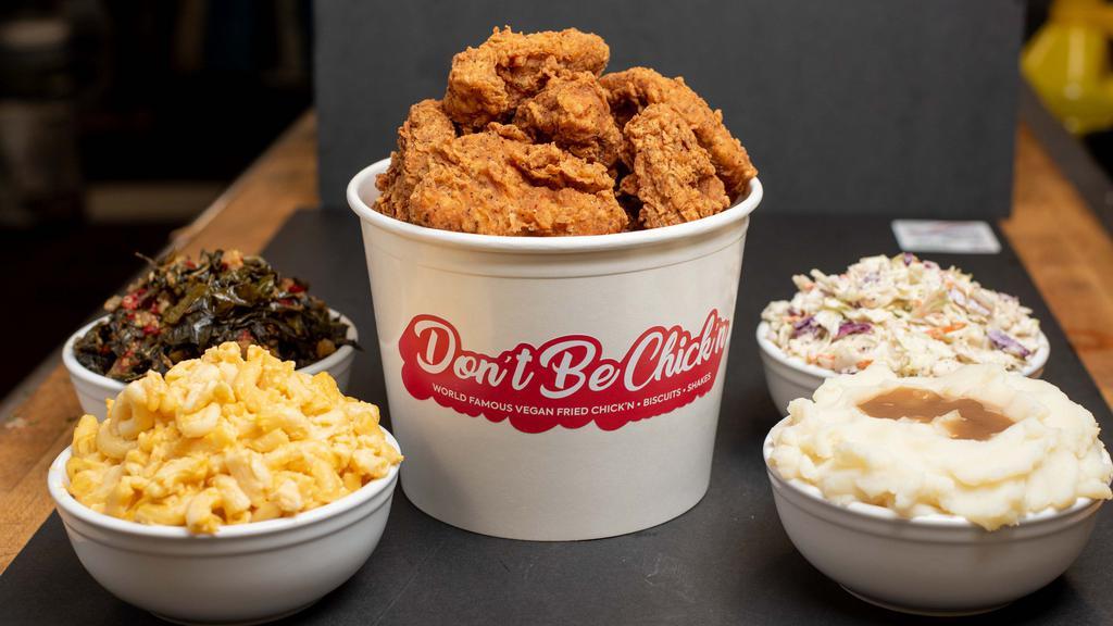 Cluckin' Bucket Family Meal · 9 piece bucket of our world famous vegan fried chick'n, two 16 oz sides of your choice, Cajun Wedges Fries, 4 dipping sauces.