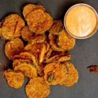 Fried Pickles · Hand breaded fried pickles served with cluck dipping sauce.