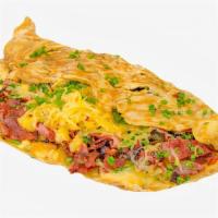 Bacon Cheddar Omelette · Three egg omelette with crispy bacon and cheddar cheese. Served with buttered toast and home...