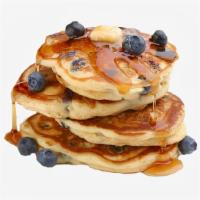 Blueberry Pancakes · Three fluffy blueberry pancakes with syrup and butter on the side.