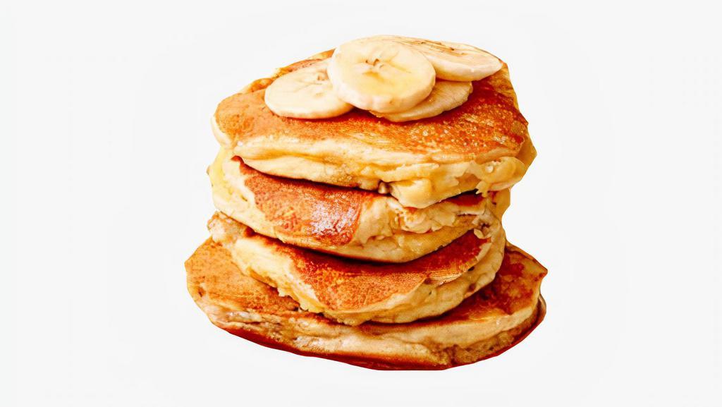 Banana Pancakes · Three fluffy banana pancakes with syrup and butter on the side.