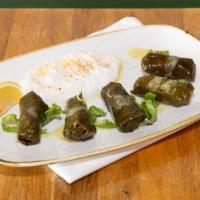 Dolmades · Vegetarian. Five pieces, grape leaves stuffed with rice, assorted herbs and spices with tzat...