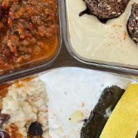 Veggie Combo Plate · No substitutions. Hummus, sautéed eggplant, dolmades, salad and falafel. Served with pita br...