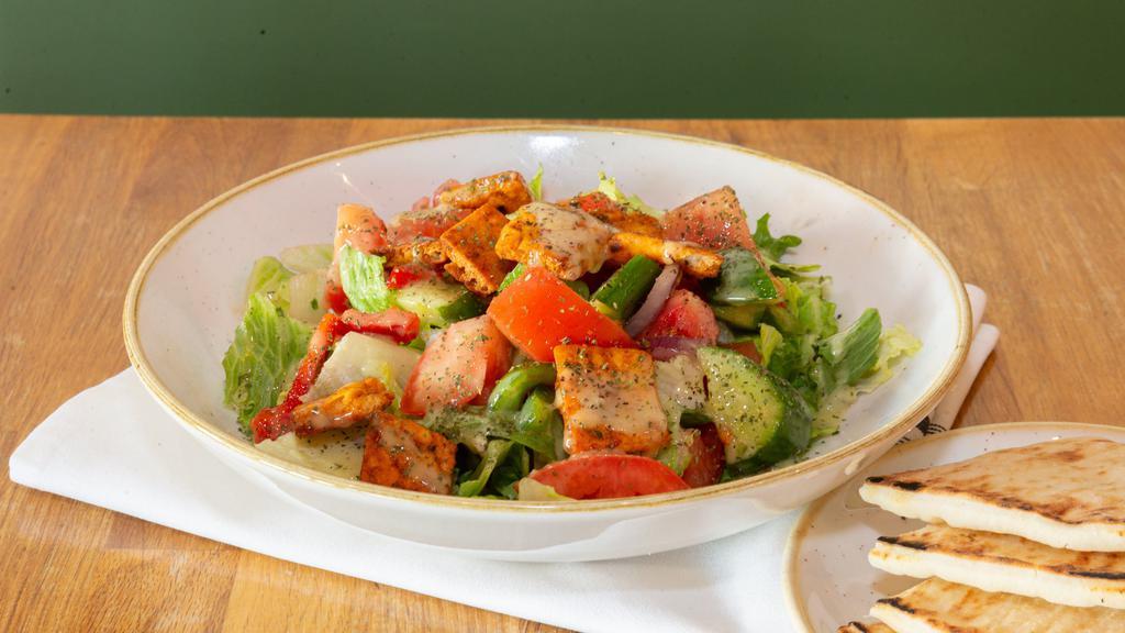 Fattoush Salad · Vegetarian. Romaine hearts, cucumber, tomato, onion, bell peppers, sumac, dried mint and  pitta chip & house dressing. Served with pita bread.