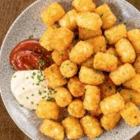 Seasoned Tater Tots · Crispy tater tots tossed in spices and served with hop aioli and smoked ketchup.