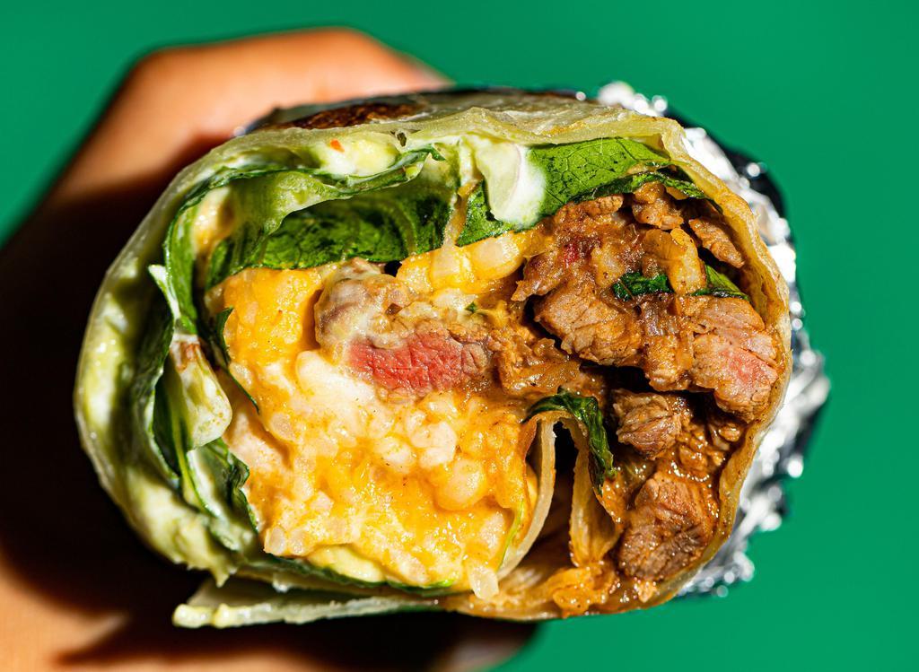 El Rico Burrito · Classic, marinated beef/chicken burrito with refried beans, Monterrey Jack cheese, sour cream, guacamole,  lettuce & our signature sauce.