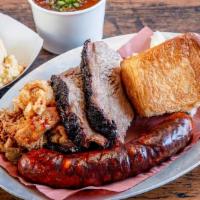 #3 Choose Three Meats · Comes with your choice of smoked meat, choice of two sides or fixin's, pickles, and a warm b...
