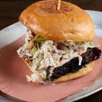 Burnt End Sando · Smoked brisket braised in BBQ sauce, with BBQ sauce, coleslaw and pickles.