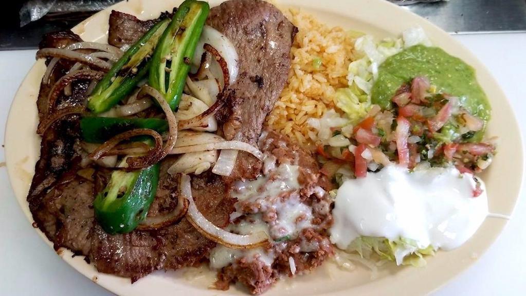 Platillo with your Choice of Meat · served on a large plate with your choice of  meat, rice, beans, sour cream, salsa, and tortillas