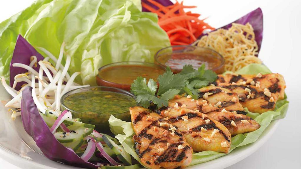 Thai Lettuce Wraps With Chicken · Create Your Own Thai Lettuce Rolls! Satay Chicken Strips, Carrots, Bean Sprouts, Coconut Curry Noodles and Lettuce Leaves with Three Delicious Spicy Thai Sauces – Peanut, Sweet Red Chili and Tamarind-Cashew
