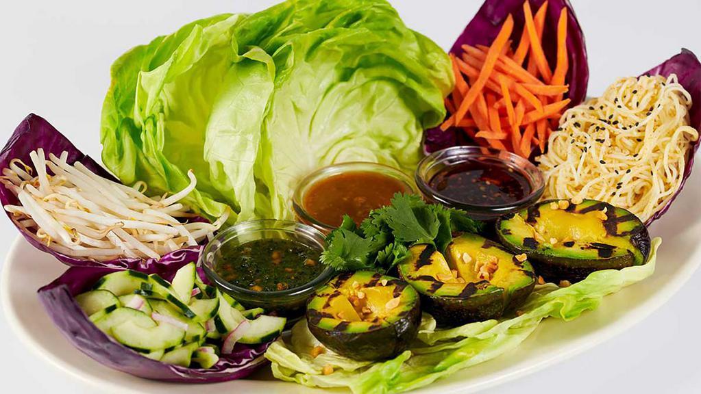 Thai Lettuce Wraps With Grilled Avocado · Create Your Own Thai Lettuce Rolls! Grilled Avocado, Carrots, Bean Sprouts, Coconut Curry Noodles and Lettuce Leaves with Three Delicious Spicy Thai Sauces – Peanut, Sweet Red Chili and Tamarind-Cashew