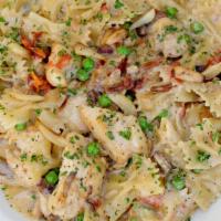 Farfalle With Chicken And Roasted Garlic · Bow-Tie Pasta, Chicken, Mushrooms, Tomato, Pancetta, Peas and Caramelized Onions in a Roaste...