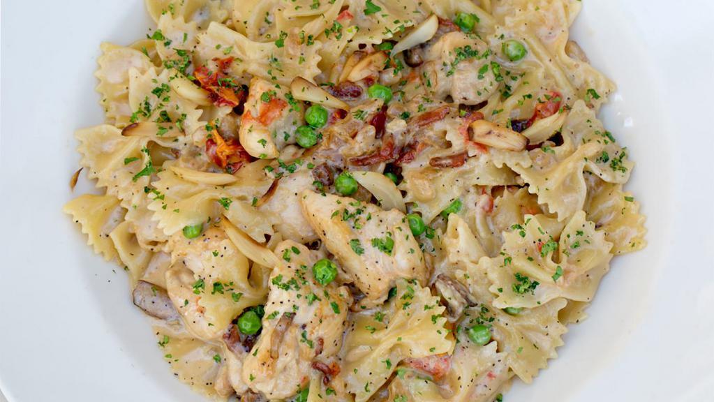 Farfalle With Chicken And Roasted Garlic · Bow-Tie Pasta, Chicken, Mushrooms, Tomato, Pancetta, Peas and Caramelized Onions in a Roasted Garlic-Parmesan Cream Sauce
