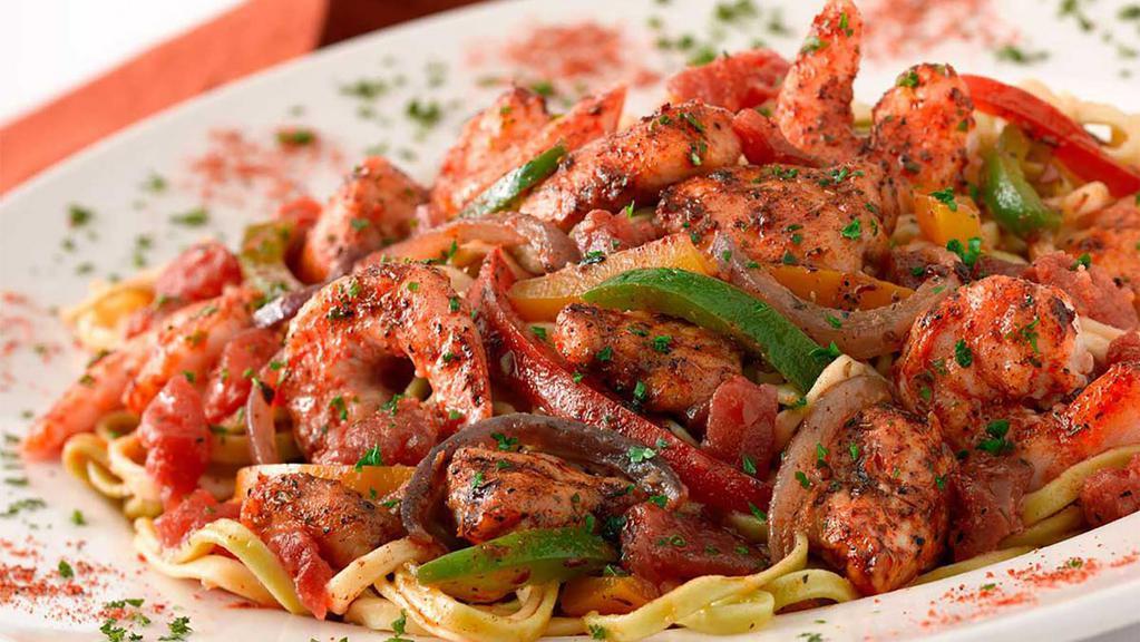 Cajun Jambalaya Pasta · Shrimp and Chicken Sauteed with Tomato, Onions and Peppers in a Very Spicy Cajun Sauce. All on Top of Fresh Linguini (Full-size portion only)