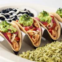 Baja Chicken Tacos · Soft Corn Tortillas Filled with Mildly Spicy Chicken, Cheese, Tomato, Avocado, Onion, Chipot...