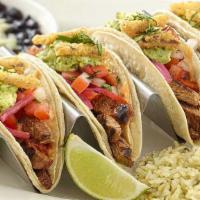 Grilled Steak Tacos · Soft Corn Tortillas, Chargrilled Steak, Avocado, Tomato, Chipotle Sauce, Crispy Onions and C...
