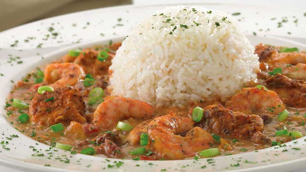 Shrimp And Chicken Gumbo · Shrimp, Chicken, Andouille Sausage, Tomatoes, Peppers, Onions and Garlic Simmered in a Spicy Cajun Style Broth with Cream. Topped with Steamed White Rice
