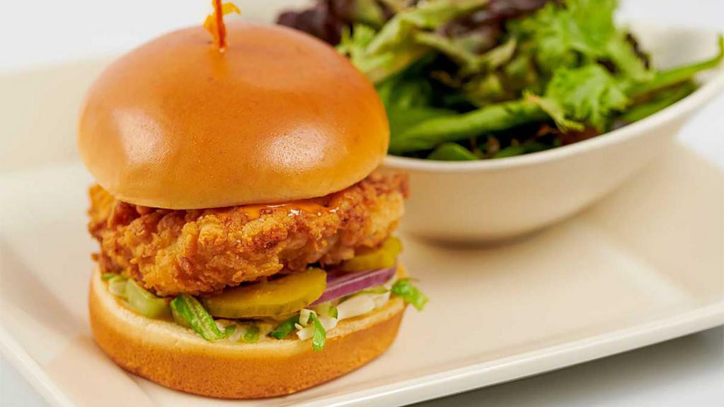 Skinnylicious® Crispy Chicken Sandwich With Spicy Sriracha Mayo · Chicken Breast Fried Crisp with Lettuce, Pickles and Onions on a Toasted Bun. Served with a Green Salad