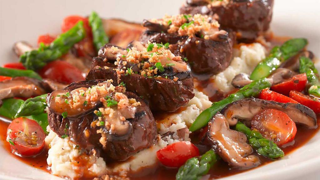 Skinnylicious® Grilled Steak Medallions · Served with Fresh Asparagus, Shiitake Mushrooms, Sauteed Cherry Tomatoes, Crusted Croutons, Mashed Potatoes and Madeira Wine Sauce