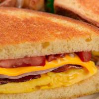 Brioche Breakfast Sandwich · Scrambled Egg, Smoked Bacon, Ham, Grilled Tomato, Melted Cheddar Cheese and Mayonnaise on Gr...