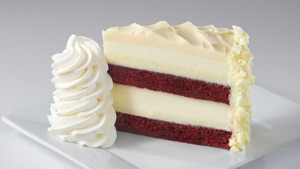 Ultimate Red Velvet Cake Cheesecake™ · Layers of Red Velvet Cake and Cheesecake Covered in Cream Cheese Frosting. Finished with White Chocolate