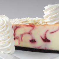 White Chocolate Raspberry Truffle® Cheesecake · Creamy Cheesecake Swirled with White Chocolate and Raspberry
