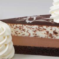 Chocolate Tuxedo Cream® Cheesecake · Layers of Our Fudge Cake, Chocolate Cheesecake, Vanilla Mascarpone Mousse and Chocolate