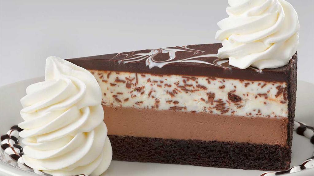 Chocolate Tuxedo Cream® Cheesecake** · Layers of Our Fudge Cake, Chocolate Cheesecake, Vanilla Mascarpone Mousse and Chocolate
