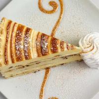 Cinnabon® Cinnamon Swirl Cheesecake · Layers of Cinnabon® Cinnamon Cheesecake and Vanilla Crunch Cake Topped with Cream Cheese Fro...