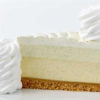 Vanilla Bean Cheesecake** · Creamy Vanilla Bean Cheesecake, Topped with Vanilla Mousse and Whipped Cream