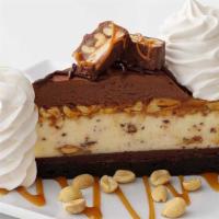 Chocolate Caramelicious Cheesecake Made With Snickers® · Original Cheesecake Swirled with Snickers® on a Brownie Crust with Chocolate, Caramel and Pe...