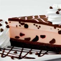 Very Cherry Ghirardelli® Chocolate Cheesecake · Cherry Cheesecake on a Layer of Fudge Cake, Loaded with Cherries and Ghirardelli® Chocolate