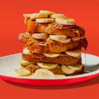 Banana Peanut Butter French Toast · Four half slices of egg-washed french toast with banana, peanut butter, maple syrup and butt...
