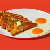 Savory French Toast Plate · Four half slices of egg-washed french toast served with two eggs.