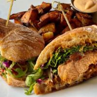 Roasted Salmon Sandwich · Ciabatta Bread, Salmon, Cabbage Salad, Pickled Onions, Spicy Aioli Sauce, Greek Fries, Maras...