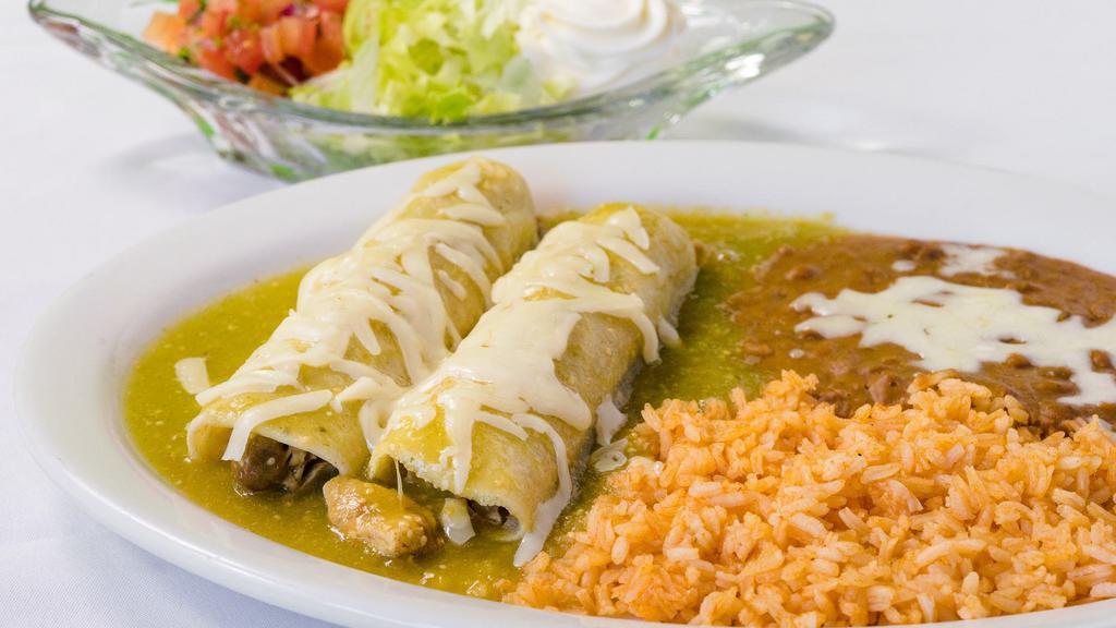Enchiladas · Two red or green enchiladas with choice of chicken or ground beef, served with rice, refried beans, lettuce, pico de gallo, cheese and sour cream