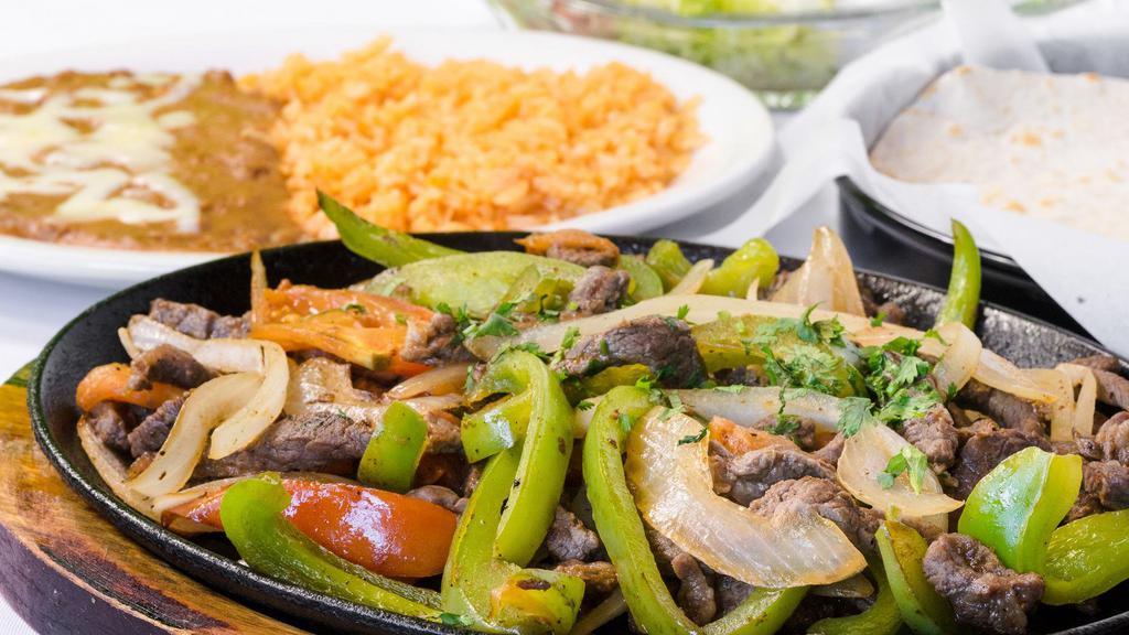 Fajitas (Steak or Chicken Mix or Shrimp) · Charbroiled steak or chicken, served on a sizzling plate with rice, refried beans and tortillas