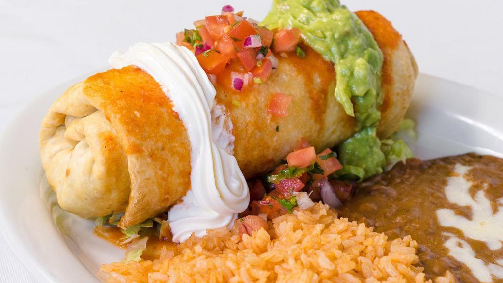 Chimichanga · A deep-fried tortilla filled with chicken or steak topped with ranchera sauce, sour cream, pico de gallo, and guacamole served with rice and beans. Add shrimp, fish and tongue for additional charge.