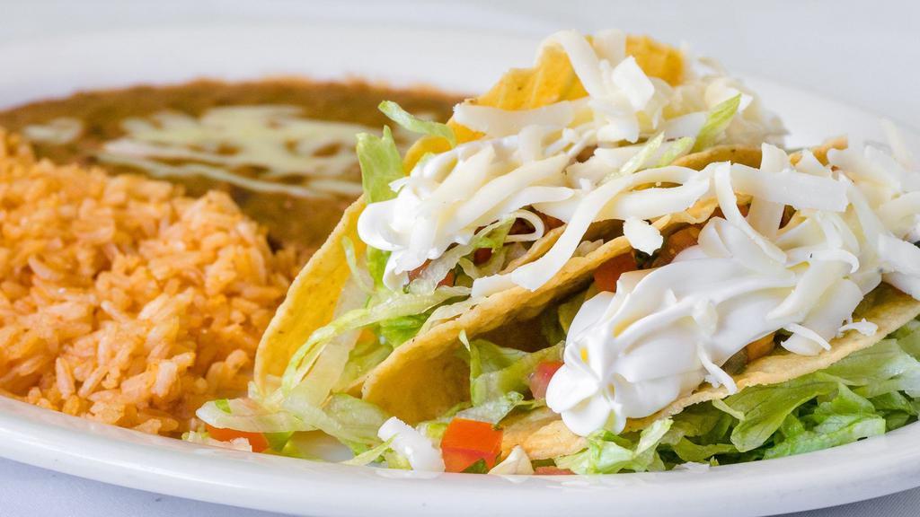 Two Crispy Shell Taco · Choice of meat served with rice, refried beans, lettuce, pico de gallo, sour cream and cheese. Add shrimp, fish and tongue for additional charge