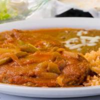 Chiles Rellenos · Two butter and fried poblano peppers stuffed with cheese and topped with ranchera sauce, ser...